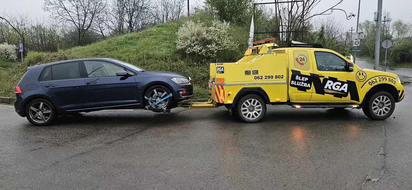 RGA transporting a passenger car on a tow platform